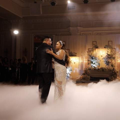 A captivating moment of a bride and groom dancing on clouds captured by wedding photography.